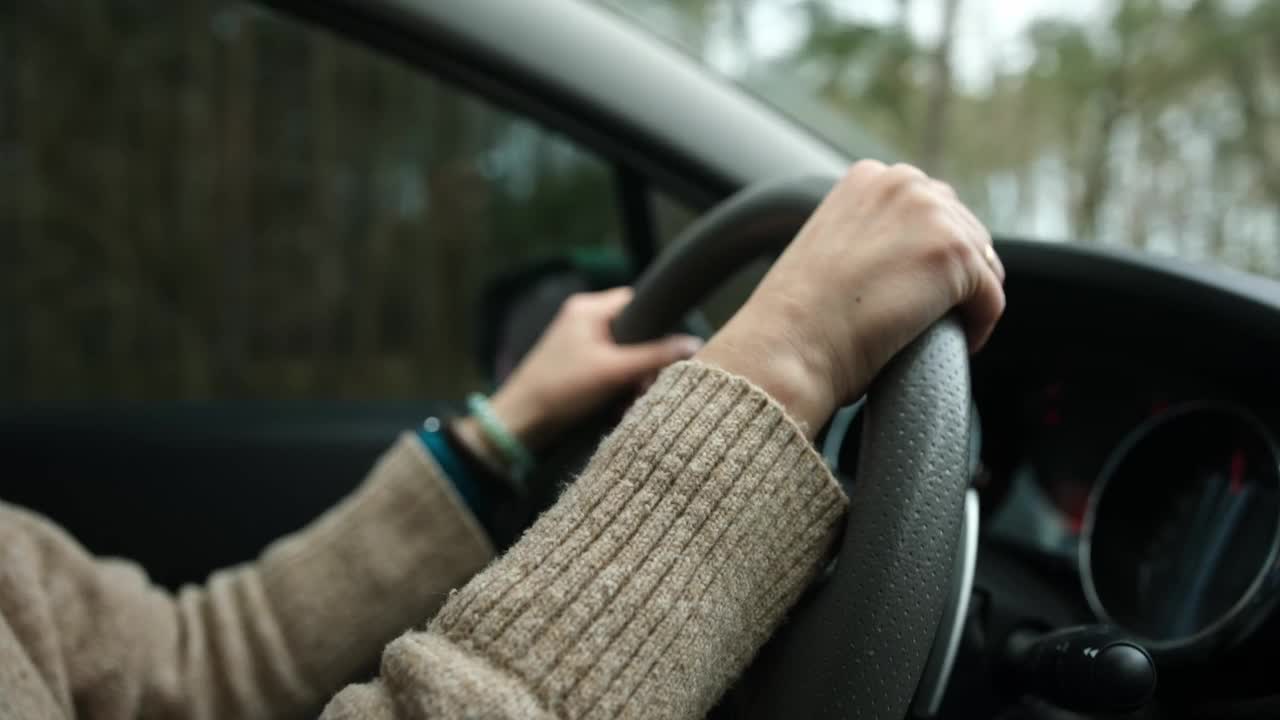 女性手握方向盘，家庭汽车里的女孩司机视频下载