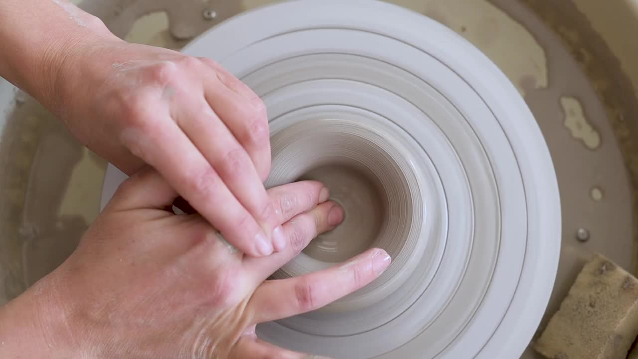 女工匠用手在陶轮上塑造粘土。现代陶艺工艺视频下载