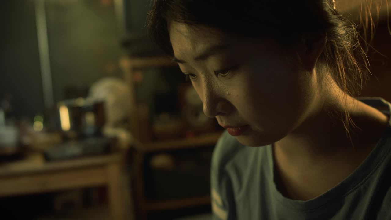 亚洲女孩在破旧的胶囊公寓里用速写本画画视频下载