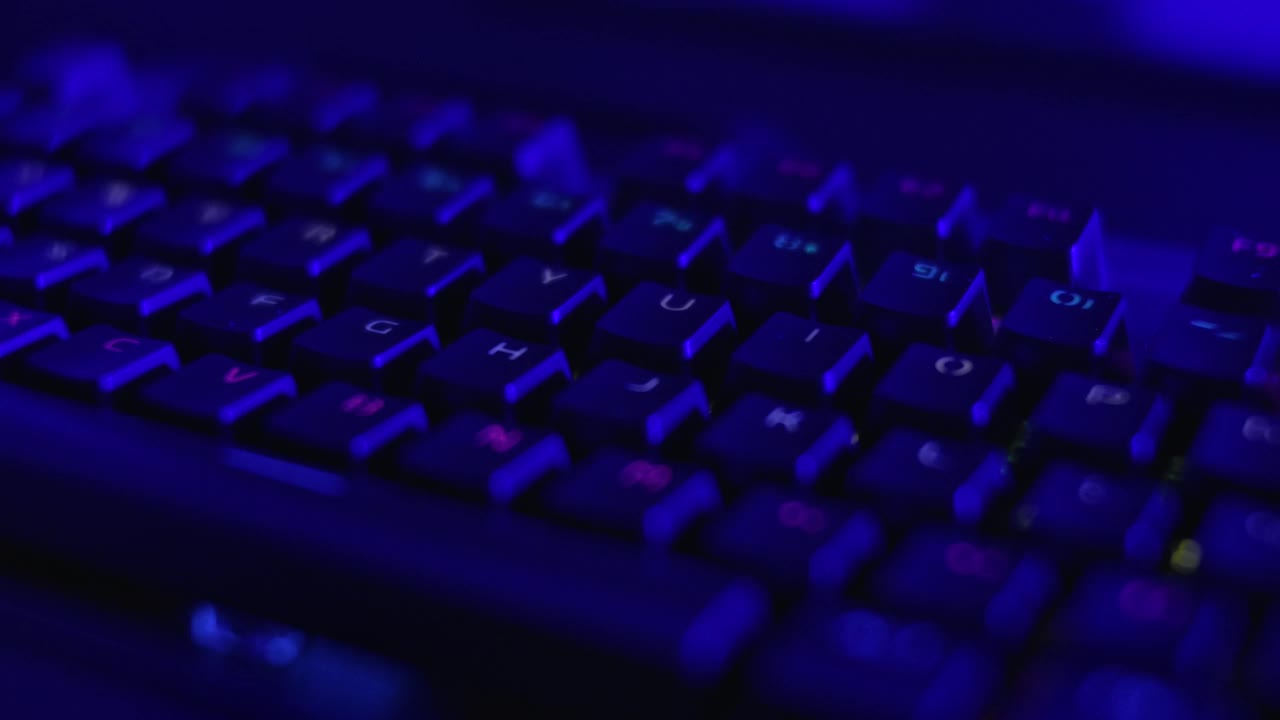 游戏键盘与彩虹的颜色字母。PC RGB键盘是发光的霓虹色。现代背光键盘与脉动RGB彩色光。电子运动照明机械游戏键盘。视频下载