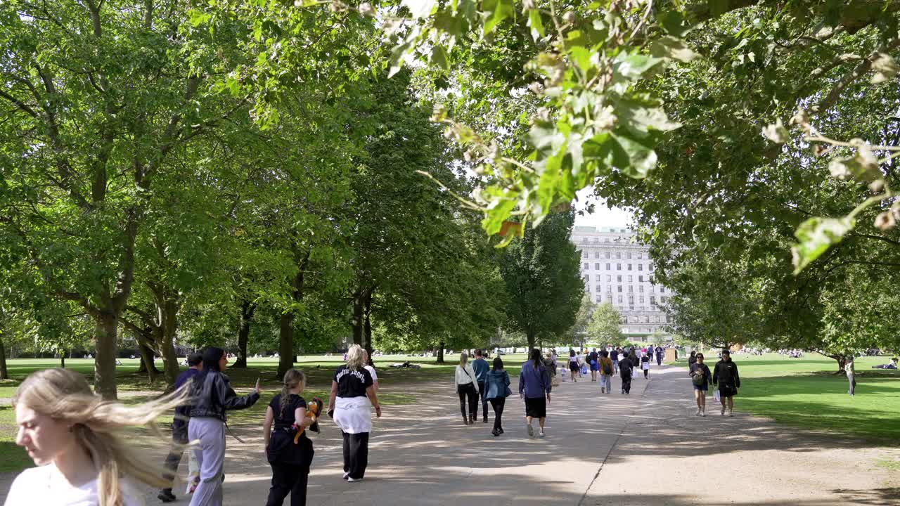 夏末漫步在伦敦绿色公园的人们视频下载