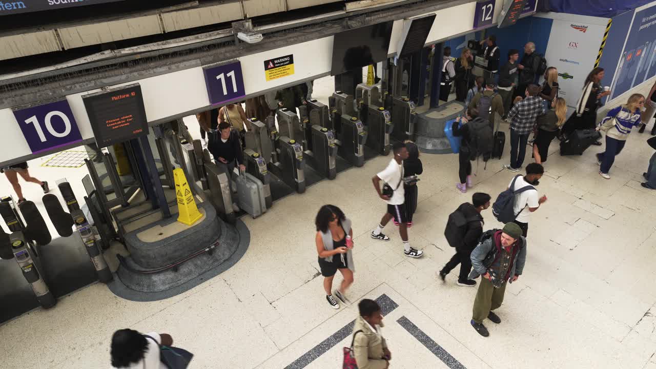 通过伦敦维多利亚站十字转门的乘客视频下载