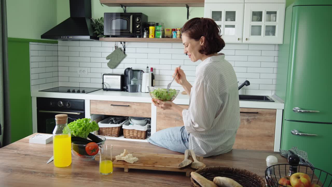 一位年轻的白人妇女正在吃新鲜蔬菜沙拉视频下载