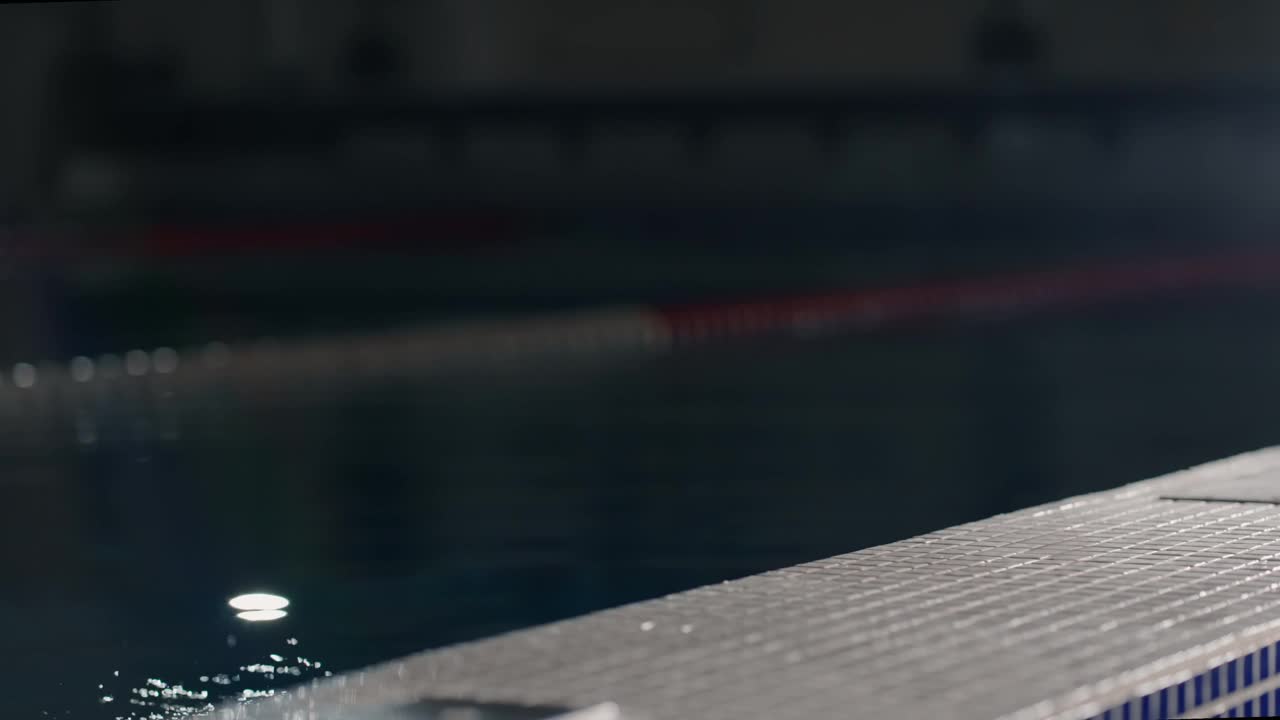疲惫的女游泳运动员从游泳池的水里出来，穿着红色泳装的运动员视频下载
