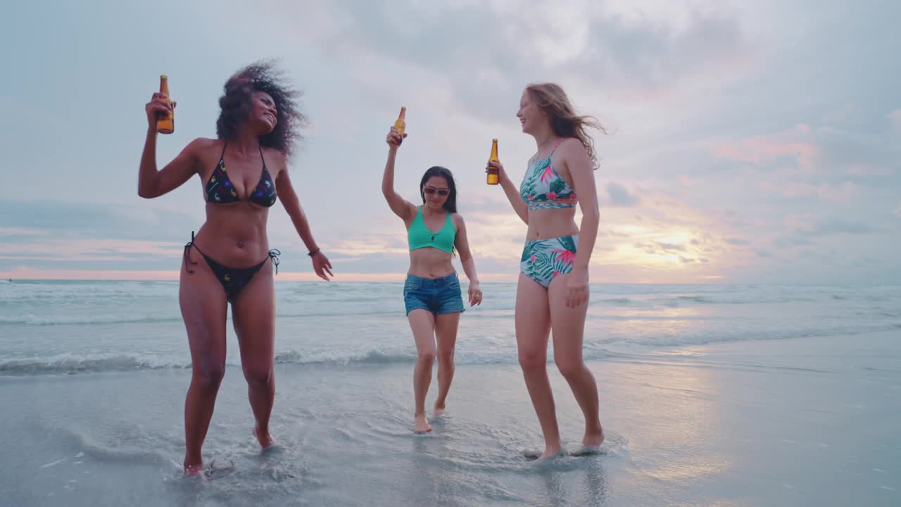一群朋友在海滩上玩，喝果汁。夏天的海滩。视频下载