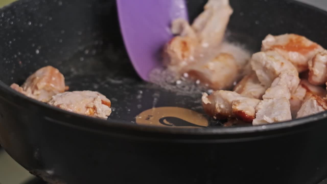 鸡块在家庭厨房的煎锅里用慢动作煎视频下载