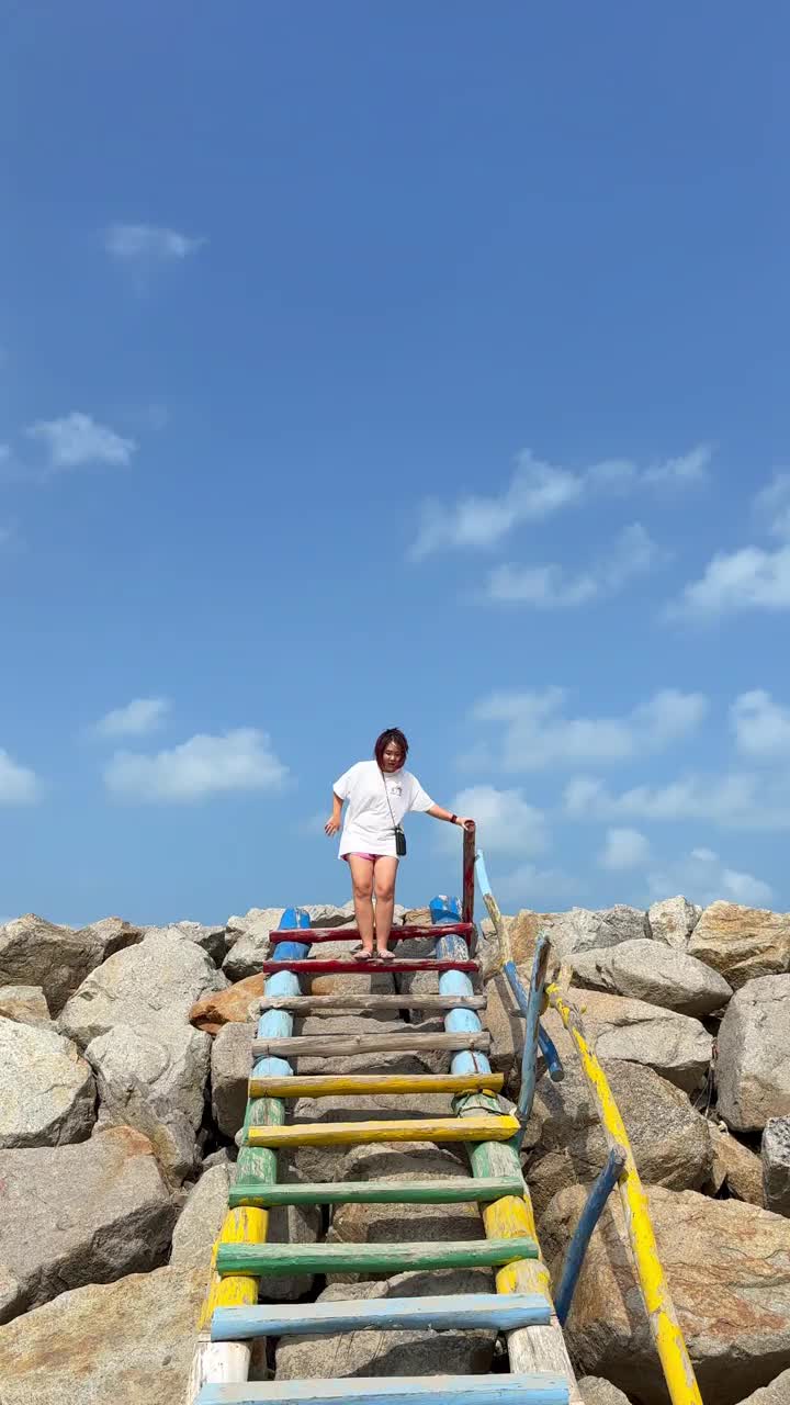 海滩上走下木楼梯的女人视频下载