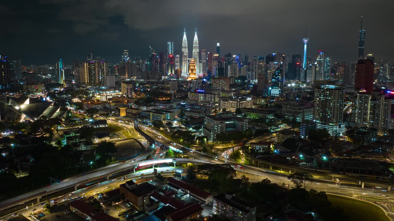 夜间照明飞行在吉隆坡中心城市景观交通道路路口航拍全景4k延时马来西亚视频下载