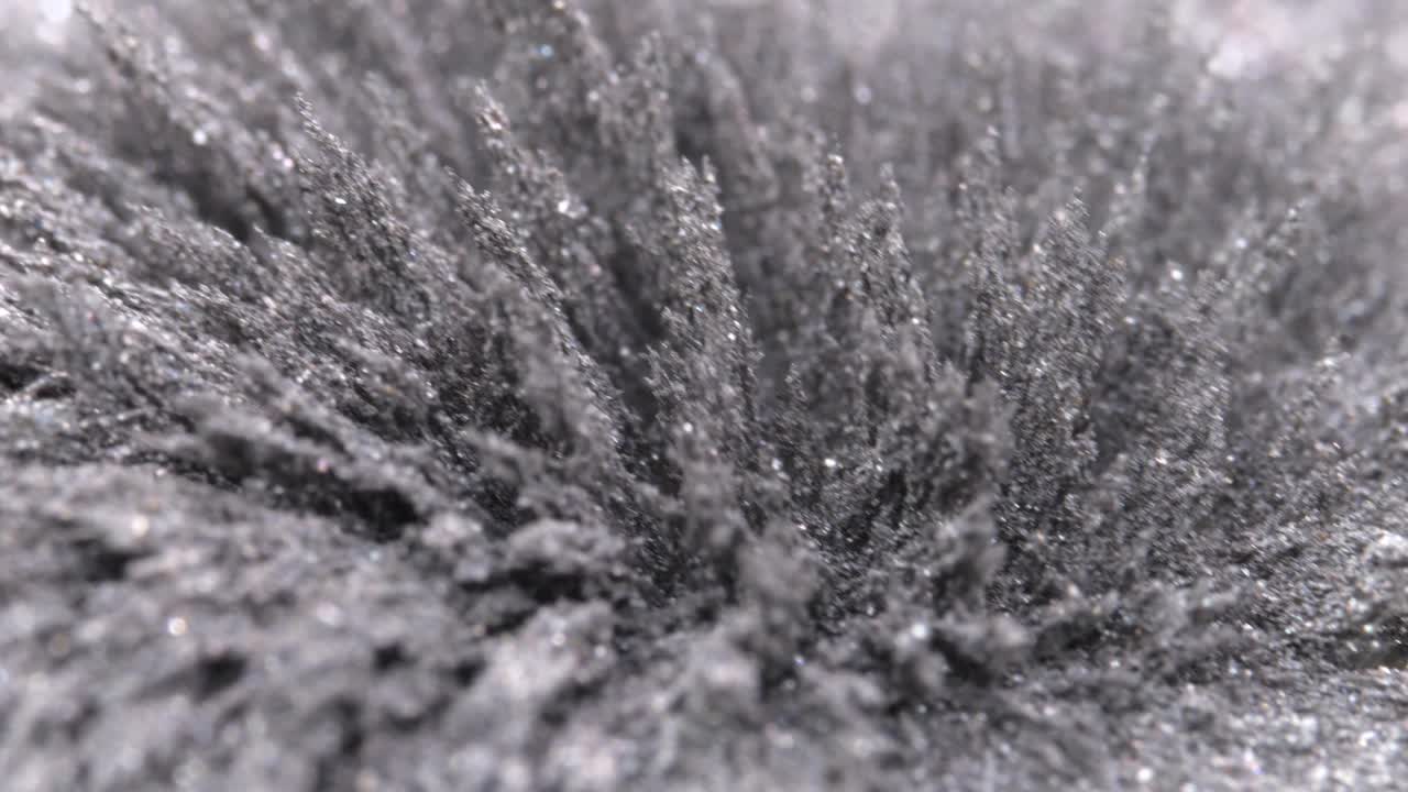 受磁场影响的金属粉尘、刨花、铁粉。抽象的背景。视频下载