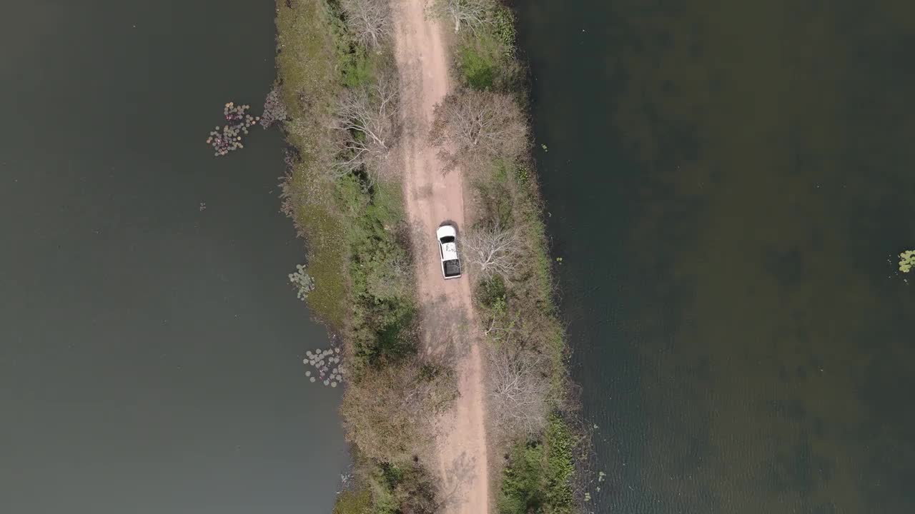 无人机拍摄鸟瞰风景，驾驶皮卡车在旱季偏僻的乡村道路上行驶视频下载