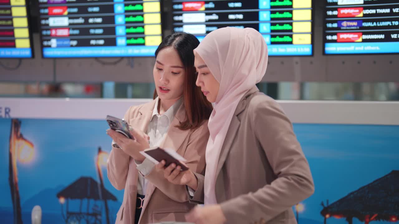 亚洲商务女性在机场查看智能手机上的航班时刻表视频下载