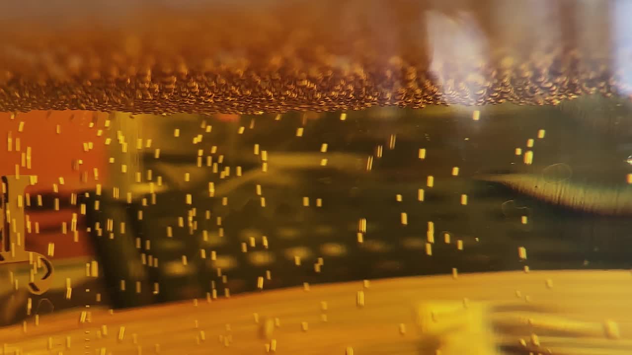 倒啤酒与泡沫泡沫在玻璃背景上的前视图波曲线形状视频下载