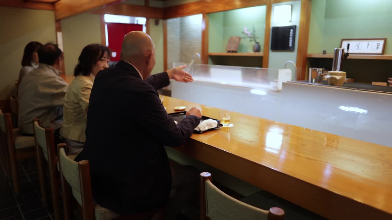 老夫妇在传统日本餐厅聊天的后视图视频下载