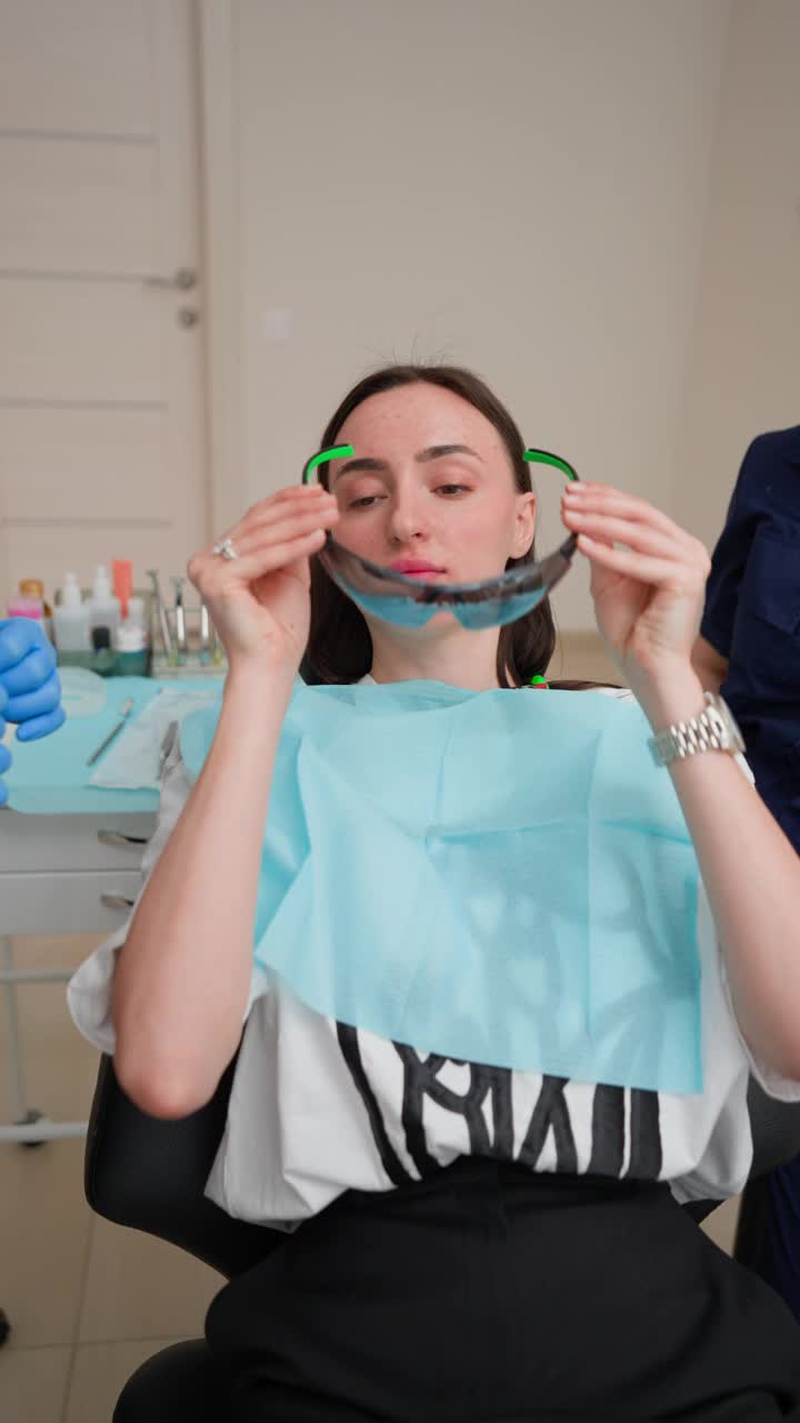 病人在牙科诊所接受牙齿治疗前戴上安全眼镜视频下载