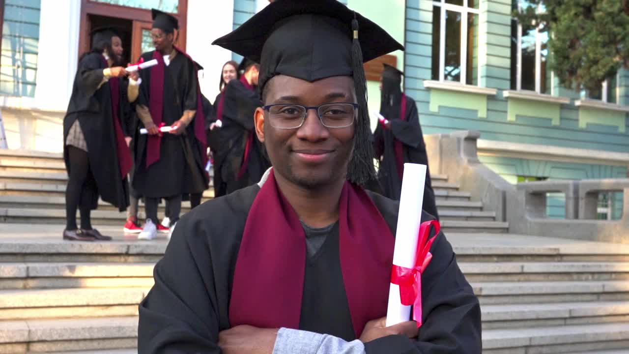 完成学位后，一名毕业生拿着他的文凭摆姿势视频下载