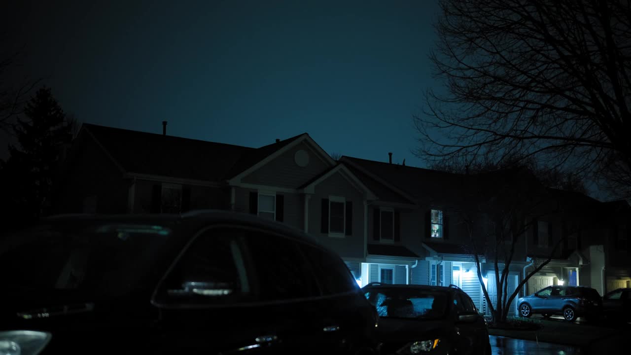 闪电在郊区的房子上方闪烁。晚上的时间。广角镜头视频下载