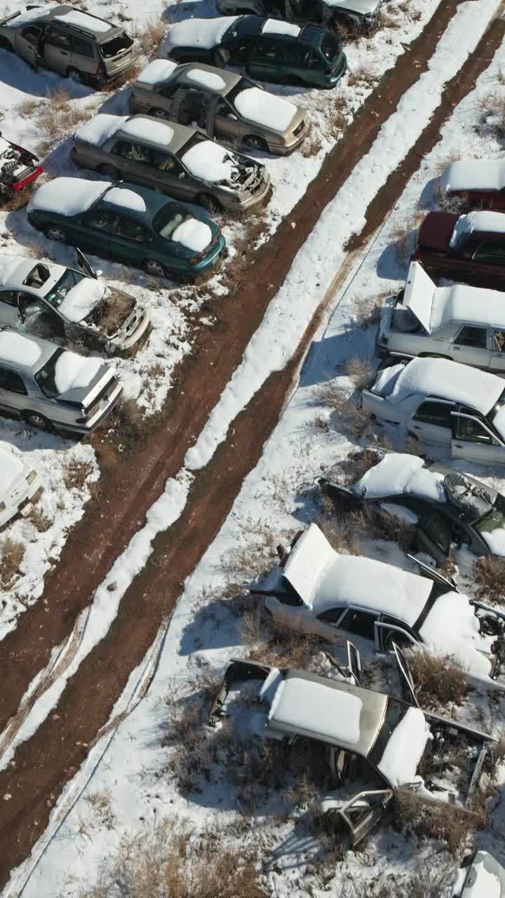 在垃圾场的一排排打捞车的空中天桥视图-垂直视频/奥罗拉，犹他州，美国视频下载