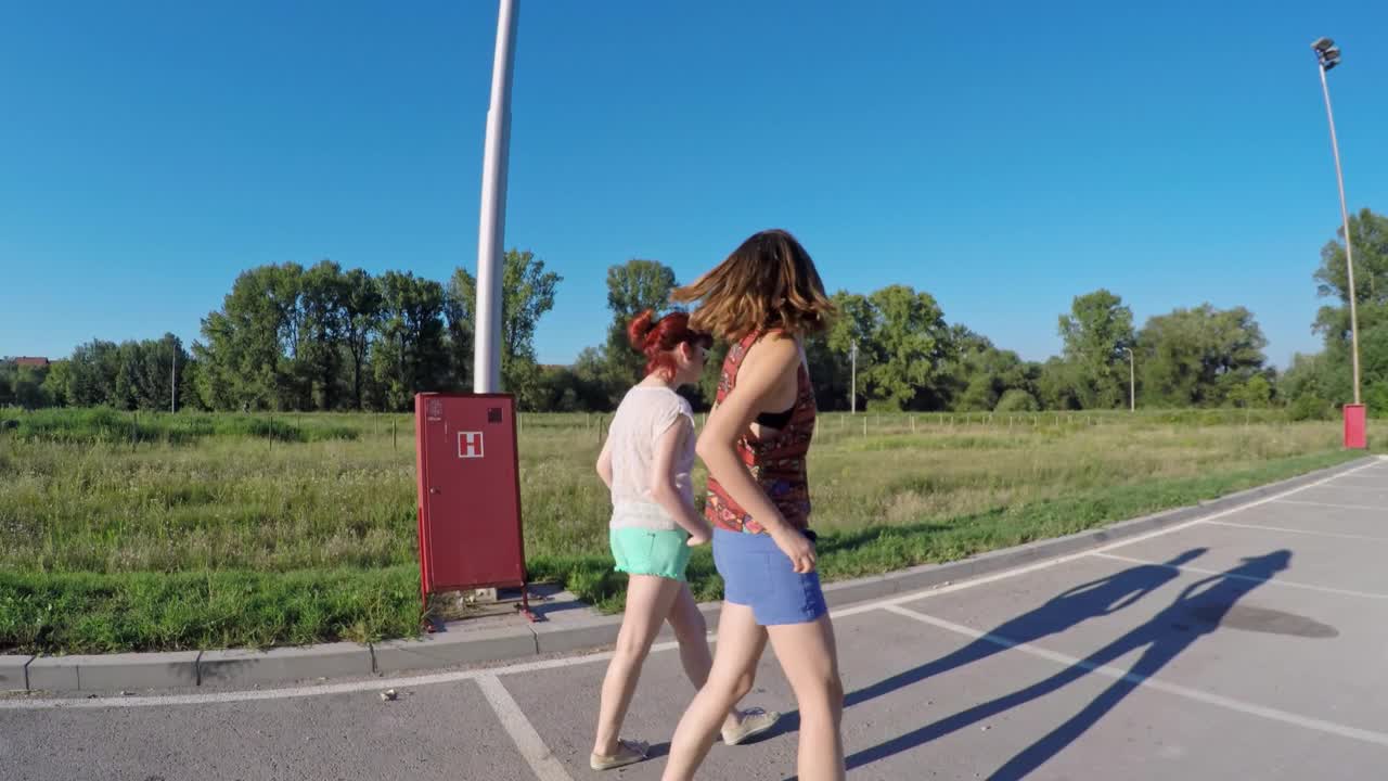 两个女性朋友并肩走在街上聊天视频下载