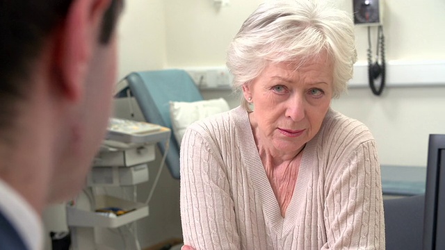 外科医生与忧心忡忡的老年女病人谈话视频素材