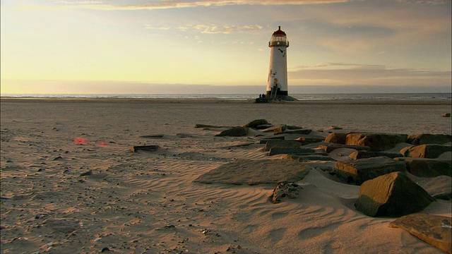 日落时海滩上的灯塔视频素材