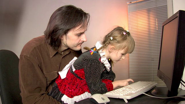 父亲和女儿与PC工作视频素材