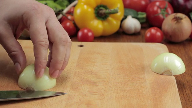 厨师用刀切洋葱，跟踪拍摄视频素材