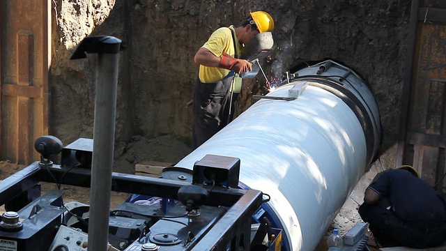 工人们在一个洞里焊接大管子视频下载