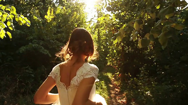 穿着复古婚纱的女人在慢动作森林里奔跑视频下载