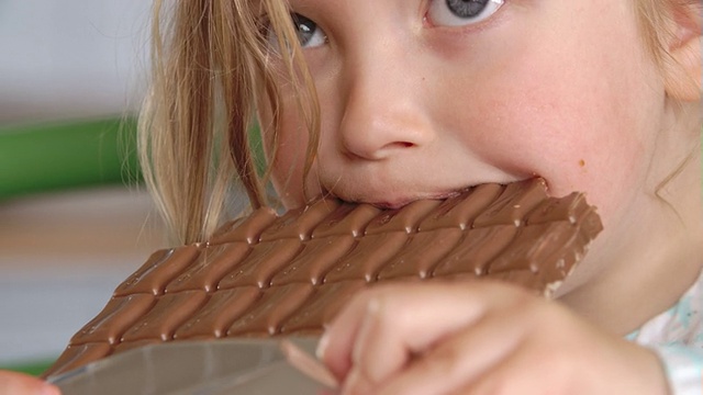 近距离的女孩吃巧克力棒视频素材