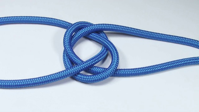 由蓝色合成绳制成的普通航海结，在白色背景上收紧视频下载
