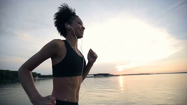日出时跑步的女人。慢动作视频素材