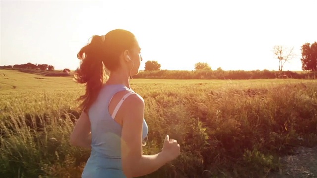 女慢跑者在日落边跑步边听音乐视频下载