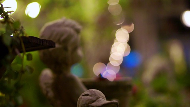 石角丘比特和鸭园装饰在夜间花园中。抽象的浪漫场景视频素材