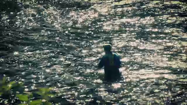 渔夫飞在波光粼粼的黄昏河钓鱼视频素材