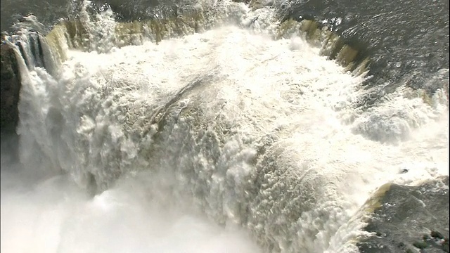 在巴西和阿根廷边境的伊瓜苏瀑布上追踪倾盆大雨，航拍视频素材
