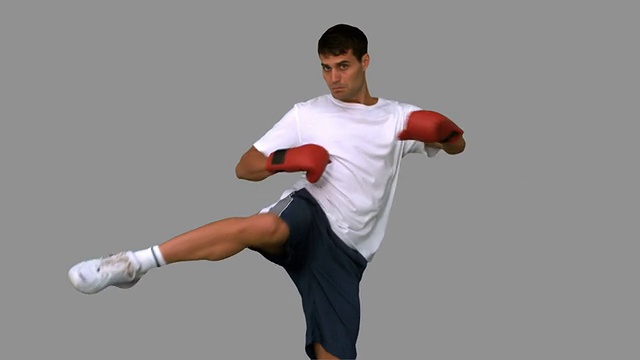 拳击手表演一个高踢灰色屏幕视频素材