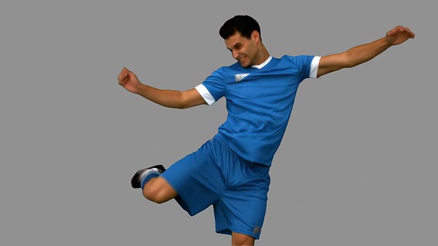 足球运动员在灰色屏幕上踢足球视频素材