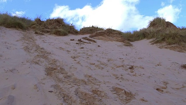男孩跑过沙丘的慢动作镜头视频下载