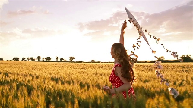 女人跑与风筝日落夏季自由慢动作视频素材