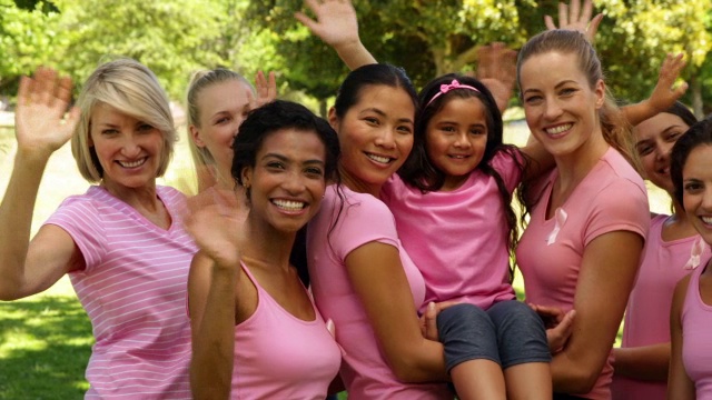 穿着粉色衣服的快乐女性为乳腺癌意识而欢呼视频下载