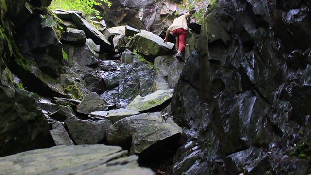 男人用慢动作爬岩石视频素材