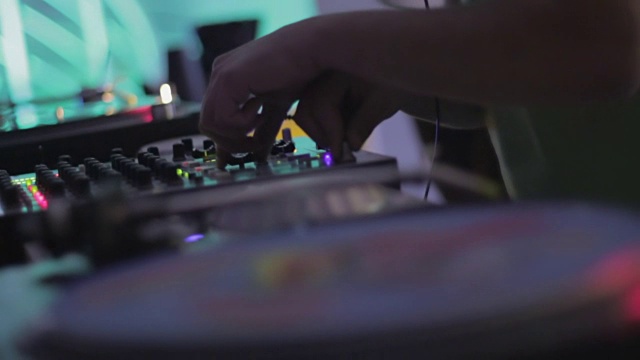 在夜总会播放音乐的男性DJ。创意乙烯基的特写视频素材