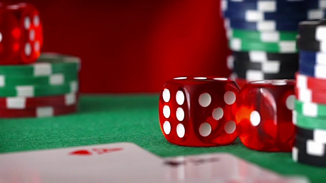 红色骰子按顺序滚动，赌场筹码，绿色毛毡上的卡片视频下载