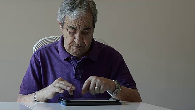 一位老人给家里的平板电脑写信视频素材