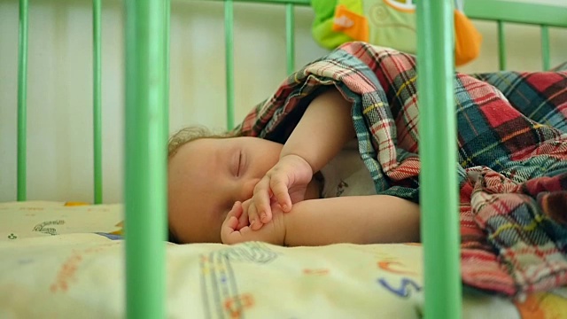 小男孩躺在婴儿床里视频素材