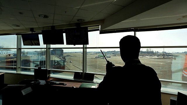 在机场，空中交通管制员正在查看距离等待无线电视频素材