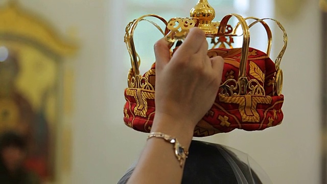 在教堂里，人们右手拿着巨大的金色皇冠视频素材