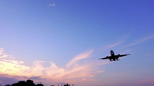 慢镜头中的飞机在秋天的夕阳中飞行视频下载