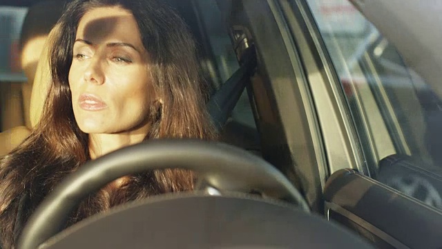 迷人的微笑商务女性驾驶汽车在明媚的阳光灿烂的一天视频素材