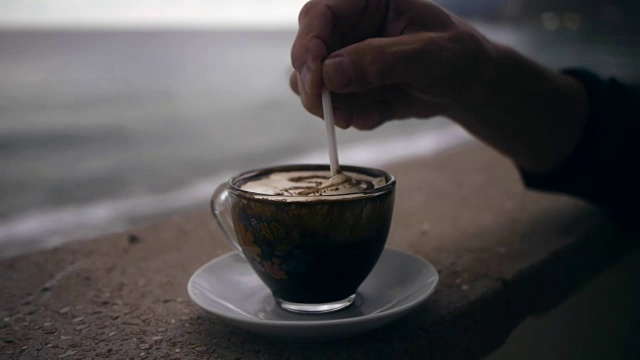用手搅动一杯咖啡中的泡沫视频素材